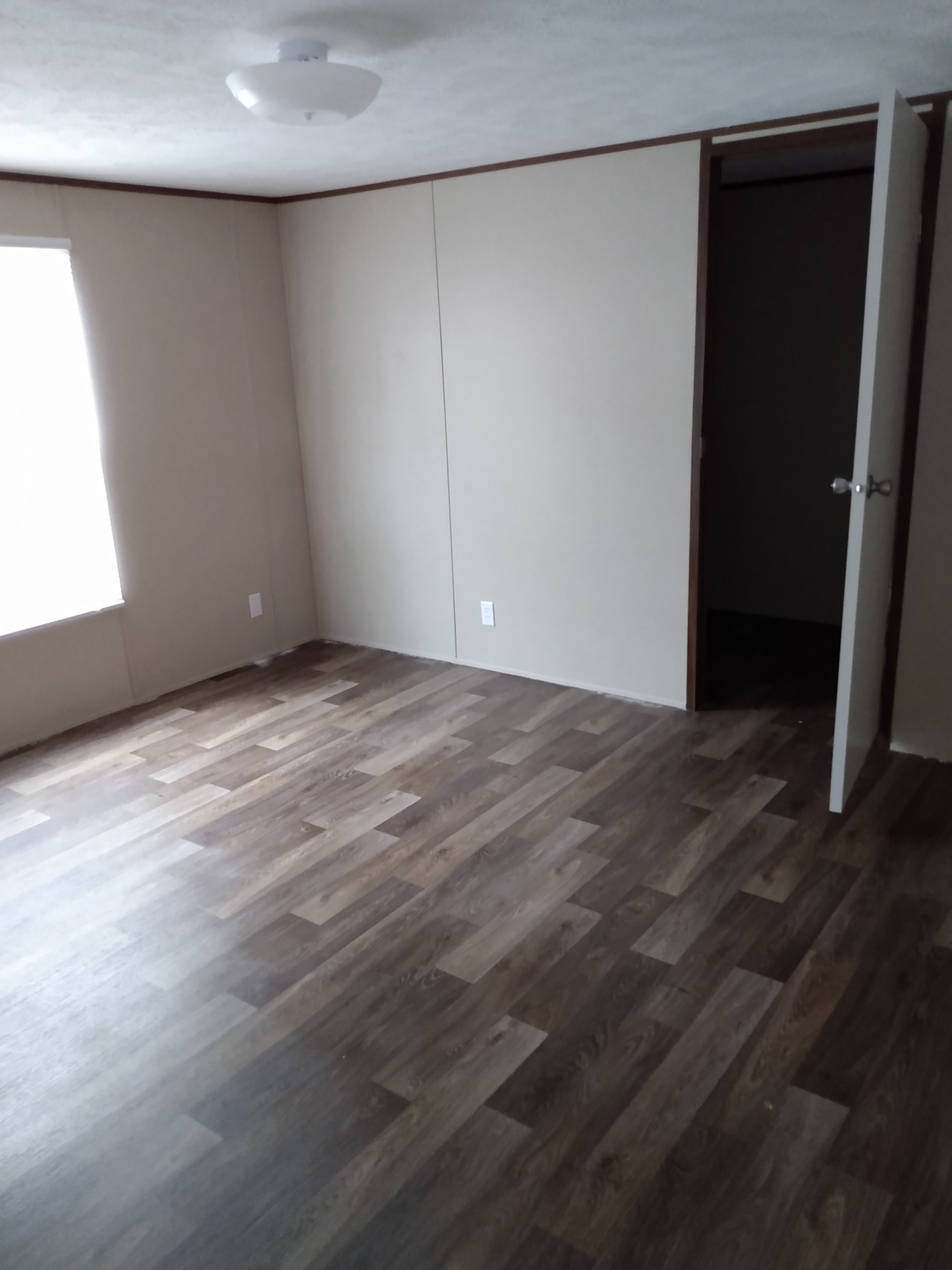 Room with a window and an open doorway